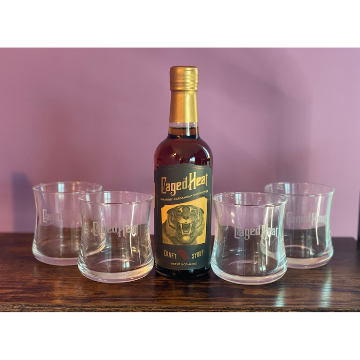 A bottle of Caged Heat or Fairy Dust Cocktail Glasses, Set of 4 with purchase of a bottle!