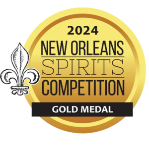 Gold Medal badge for the 2024 New Orleans Spirits Competition; circular gold seal with a fleur-de-lis on the left and a black ribbon that reads 'GOLD MEDAL'